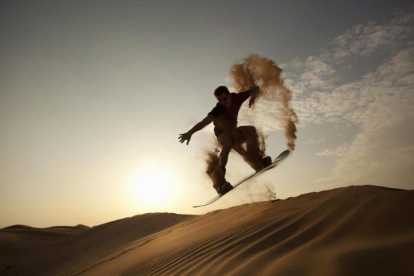 Sandboarding in desert